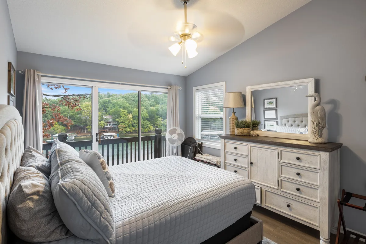 A well-equipped kitchen featuring a central island with stools, stainless steel appliances, and sleek cabinetry. The kitchen is designed for both cooking and casual gatherings, with thoughtful touches like artwork above the cabinets and plenty of counter space.